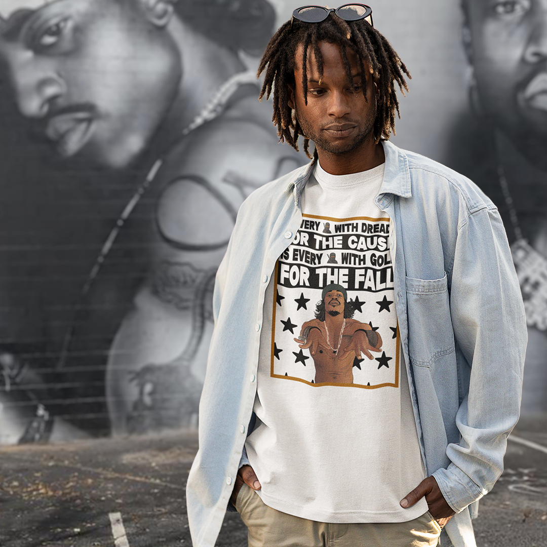 Person wearing a Outkast Andre 3000 graphic t-shirt with text and images, standing in front of a mural.